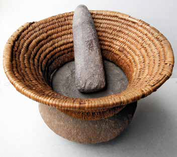 Two rocks for grinding placed in a woven basket