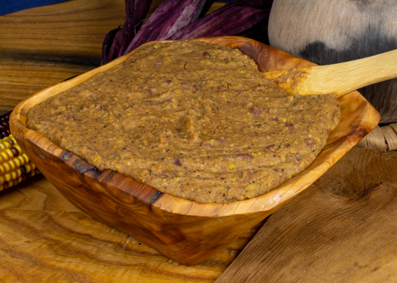 Bowl of yellow-brown porridge-like meal made from the Four Sisters