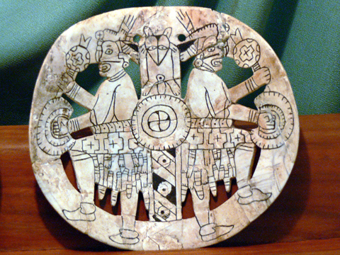 Roundish shell with two Mayan-like figures