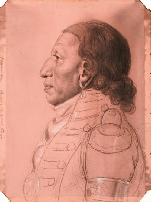 Indian wih curly hair posing in profile and wearing a army uniform coat