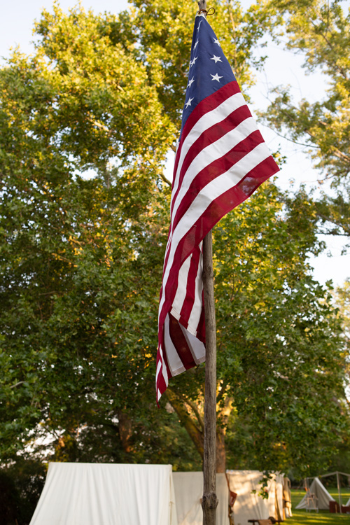 Early American flag an military encampment
