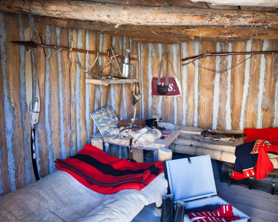Log cabin with two beds and a table