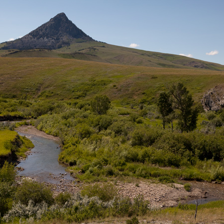 A sharp pointed mountain and small creek