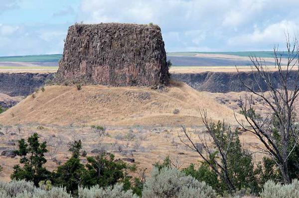 A tall, round mass of columnar basalt