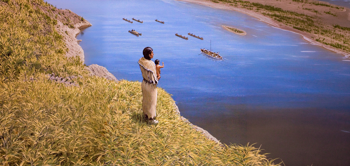 Sacagawea and her son wave goodbye as the Corps paddle away