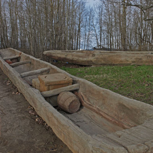 Two dugout canoes on the Columbia River shore