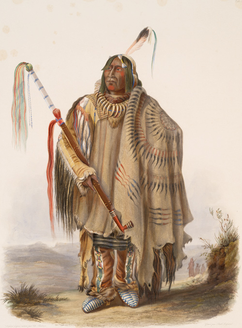 Indian wearing a painted buffalo robe and carrying a very long peace pipe