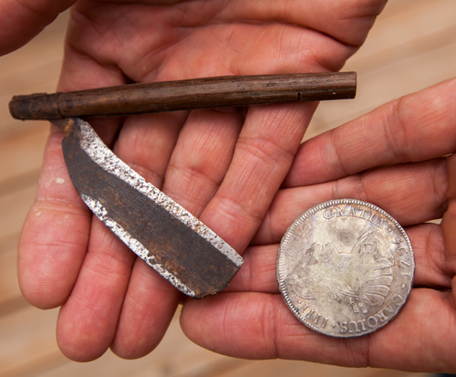 Old straight razor and silver dollar