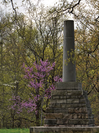 A stone base with a large broken column