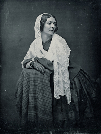 Historic photo of a dark-haired lady wearing a long shawl