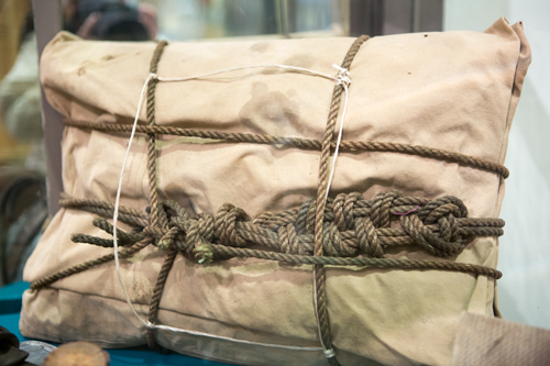 A canvas bundled tied with thick rope and long knots
