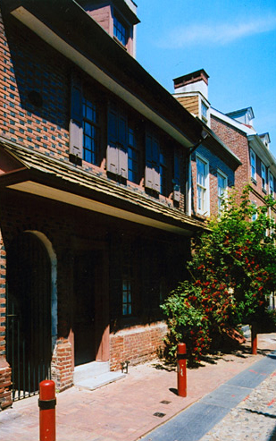 A well-kept colonial style building made of black and red brick