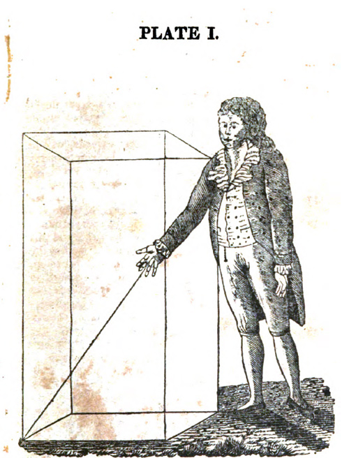 A boy points to the ground at a 45 degree angle while leaning forward
