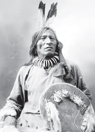 Brave with two eagle feathers, bear claw necklace, and a leather shield