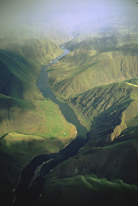 Deep canyon with green hills and a large river encountered during Ordway's fishing trip