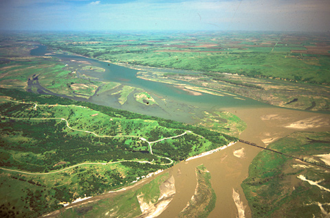Aerial photo of a muddy river joining a clearer one