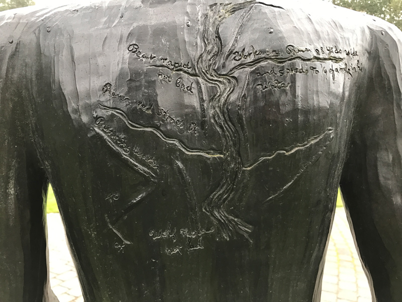 A black man's back inscribed with a map