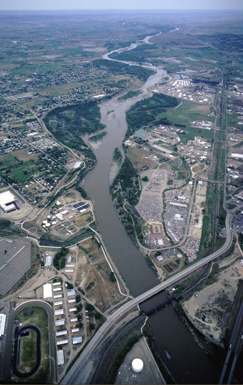 Aerial photo of a freeway crossing a river in a flat valley
