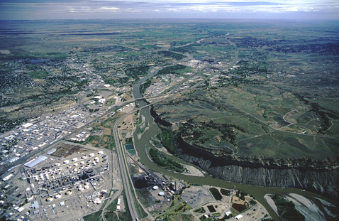 Aerial photo of oil refineries, freeway, and river cutting a bluff