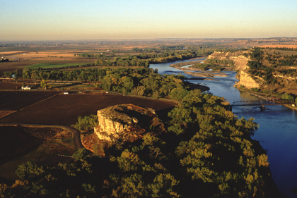 View of Pompeys Pillar showing stands of dense and tall cottonwood trees